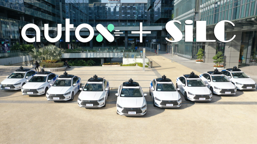 a fleet of white robotaxis showing partnership between AutoX and SiLC